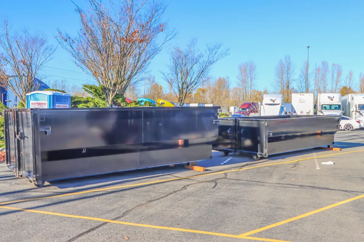 Professional dumpster rental service with roll-off container on residential driveway in Cherry Hills Village